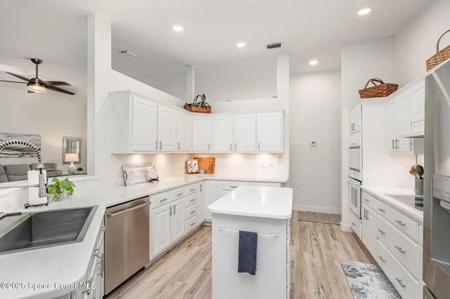a kitchen with a sink stove and refrigerator