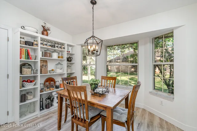 a dining room with furniture and a window