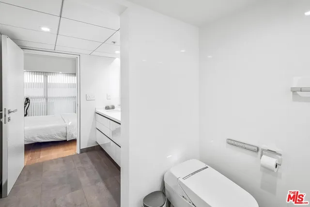 a bathroom with a toilet a sink a tub and mirror