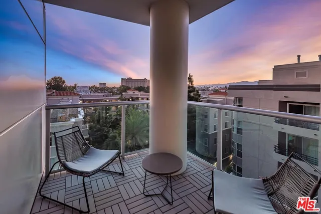 a view of a balcony with chair and a potted plant