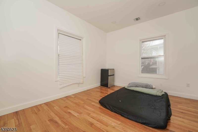 21 Woodland Road Bloomfield, NJ 07003 - Photo 15 of 20 a room with a bed and a window