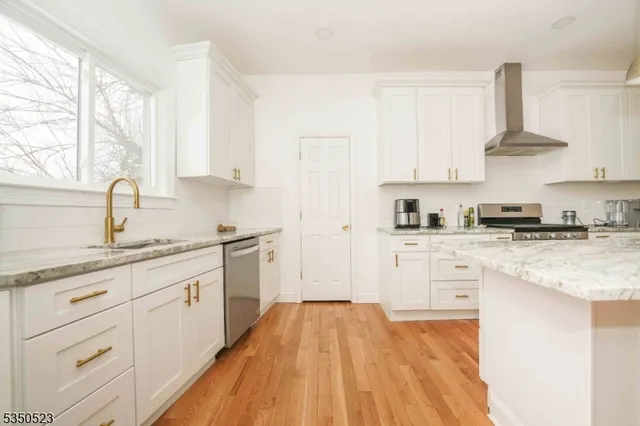 a kitchen with granite countertop white cabinets and white appliances