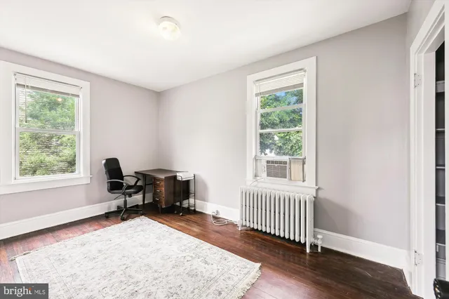 a workspace with wooden floor and a window