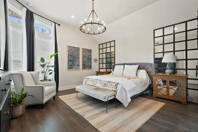 a dining room with furniture a potted plant and wooden floor
