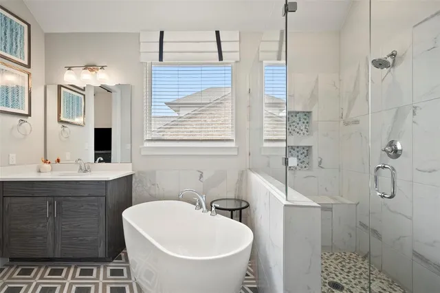 a spacious bathroom with a bathtub sink and mirror