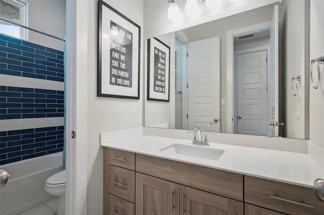 a bedroom with a bed and a desk