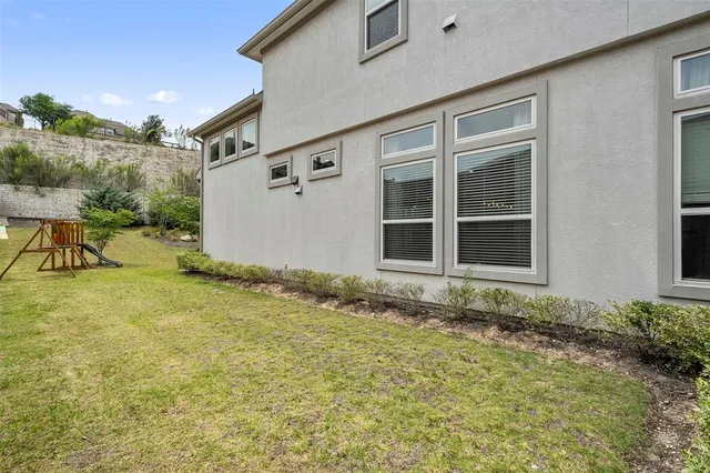 a view of a house with backyard porch and sitting area