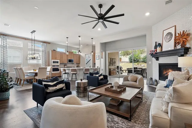 a living room with furniture kitchen view and a fireplace