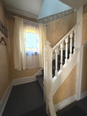 a view of an entryway with wooden floor