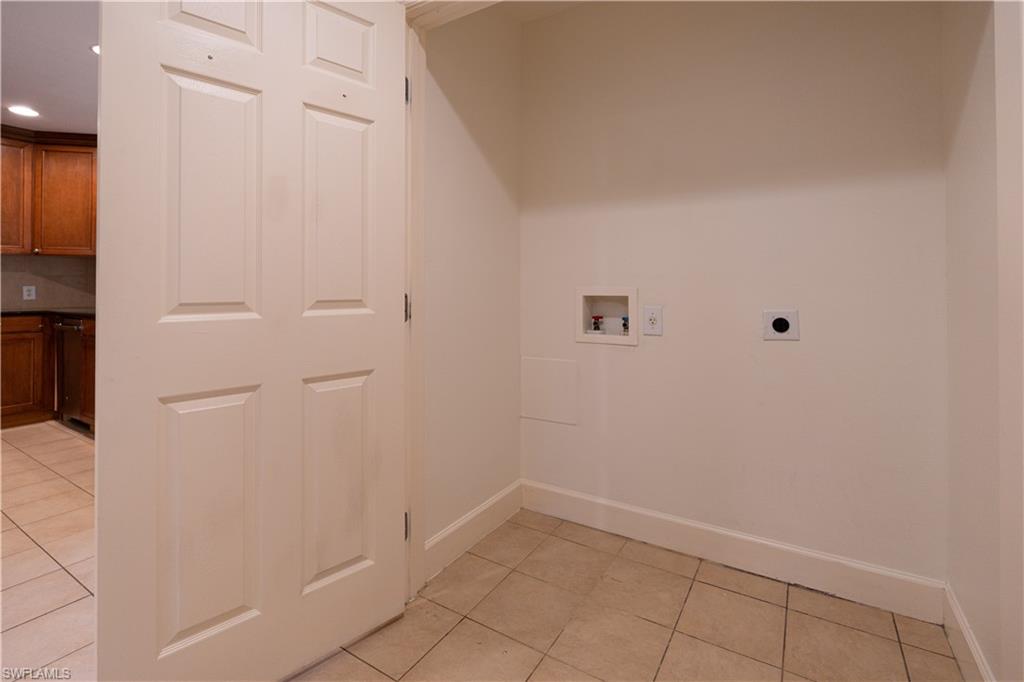 1362 Centre Ct Ridge Drive, Unit 101 Reunion, FL 34747 - Photo 21 of 25 Washroom featuring hookup for an electric dryer, hookup for a washing machine, and light tile floors