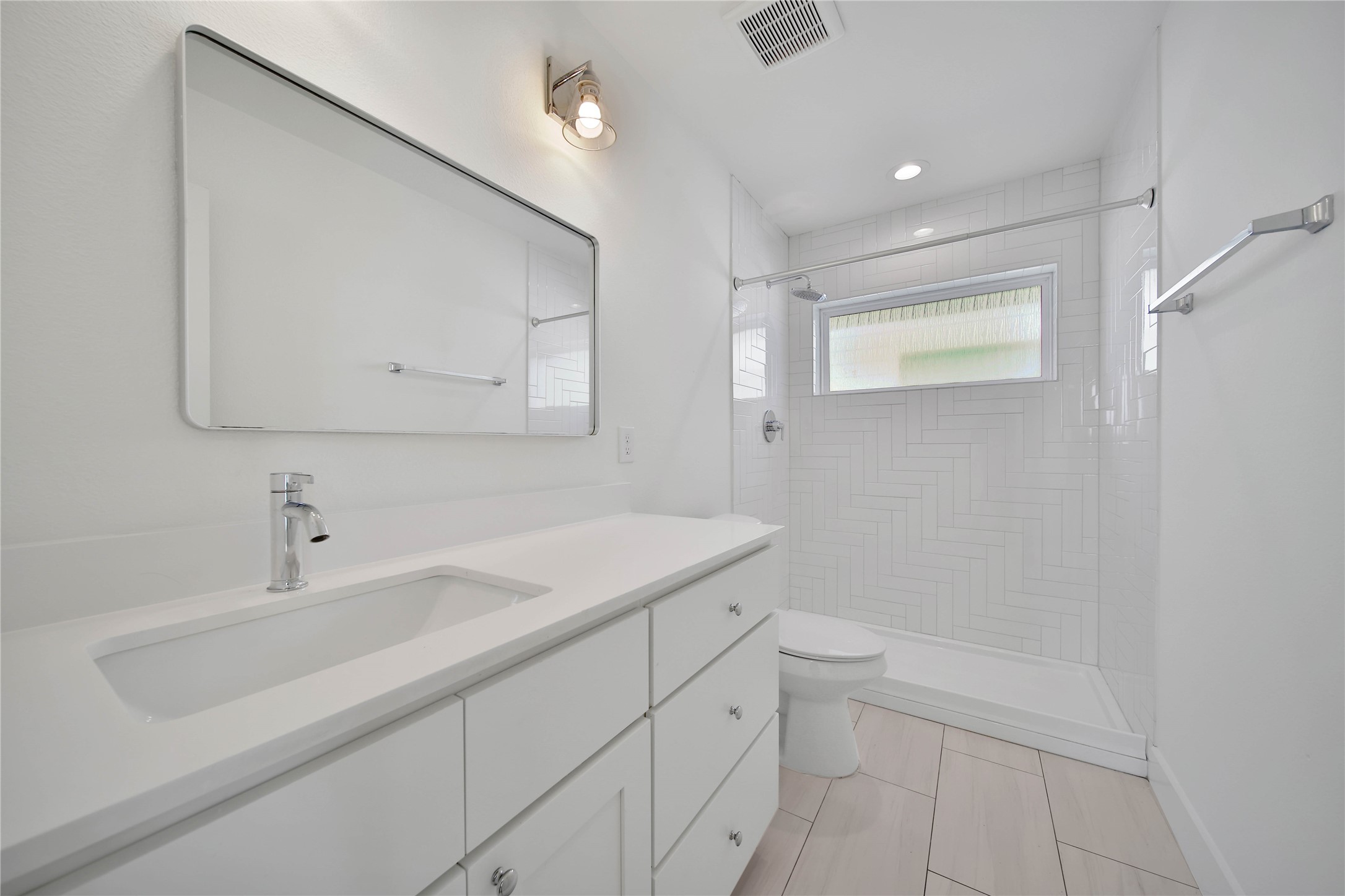 7407 Rusk Street, Unit B Houston, TX 77011 - Photo 16 of 24 a bathroom with a sink a toilet and a mirror