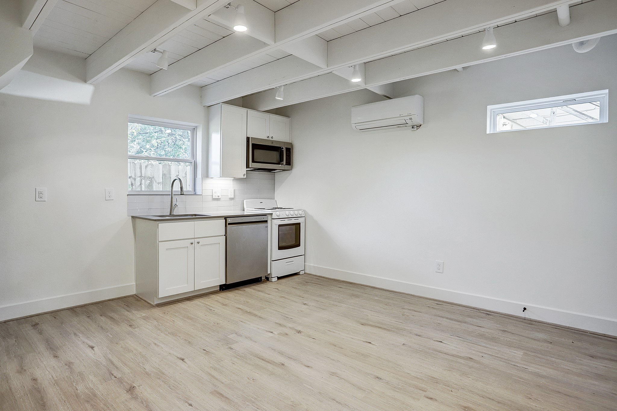 7407 Rusk Street, Unit B Houston, TX 77011 - Photo 3 of 24 a kitchen with a sink cabinets and wooden floor