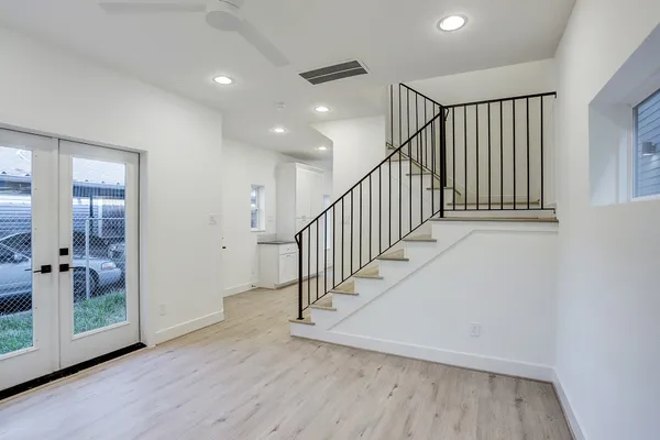 a view of room with stairs and wooden floor