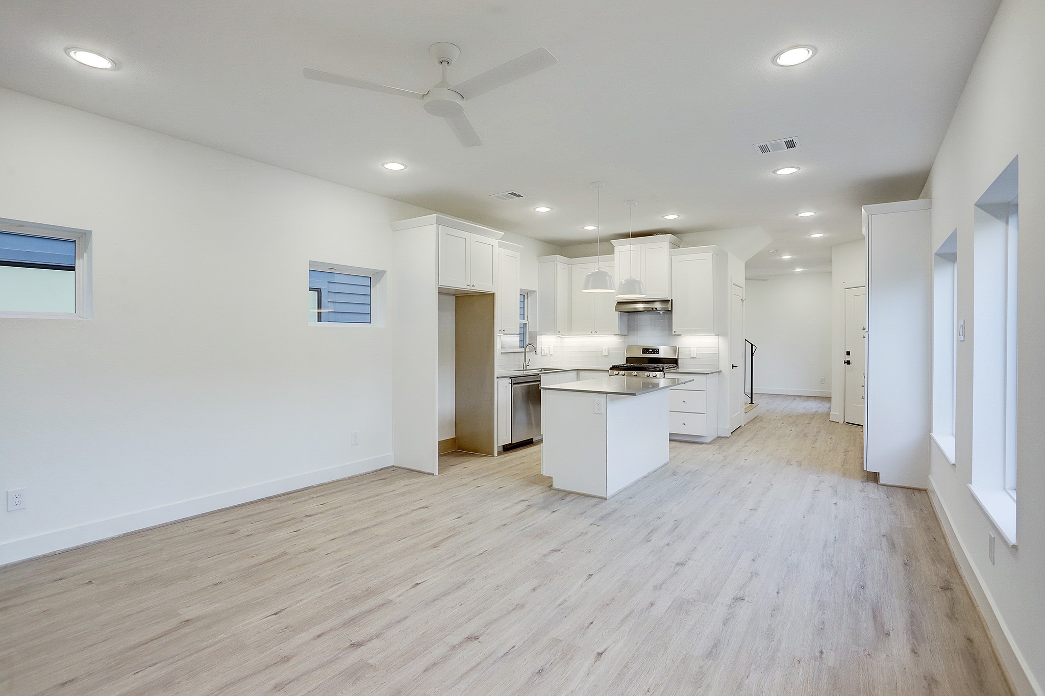 7407 Rusk Street, Unit B Houston, TX 77011 - Photo 9 of 24 a view of kitchen with stainless steel appliances kitchen island granite countertop a refrigerator and a stove top oven