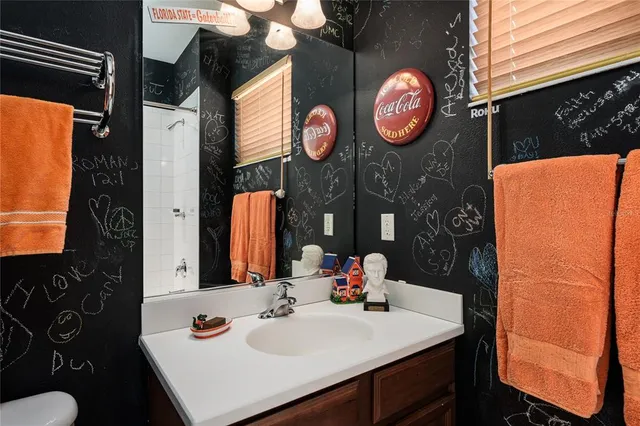 a en suite bathroom with a sink double vanity and a mirror