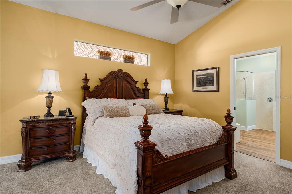 6552 Tailfeather Way Bradenton, FL 34203 - Photo 20 of 65 a bedroom with a bed and a chandelier
