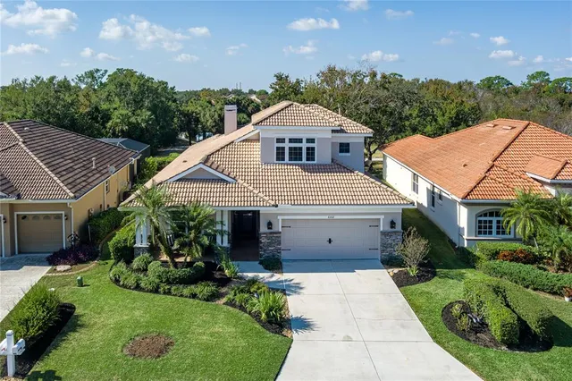 an aerial view of a houses with a lake view