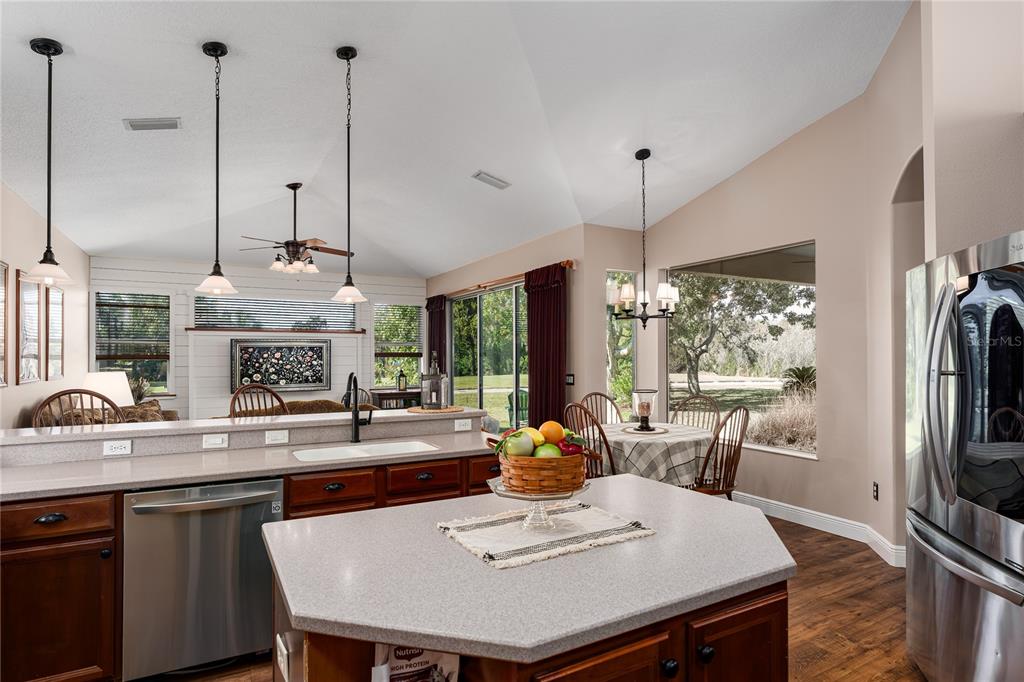 6552 Tailfeather Way Bradenton, FL 34203 - Photo 6 of 65 a kitchen with a table chairs and white appliances