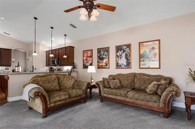 a kitchen with stainless steel appliances granite countertop a stove a sink dishwasher a refrigerator and a microwave oven with wooden floor