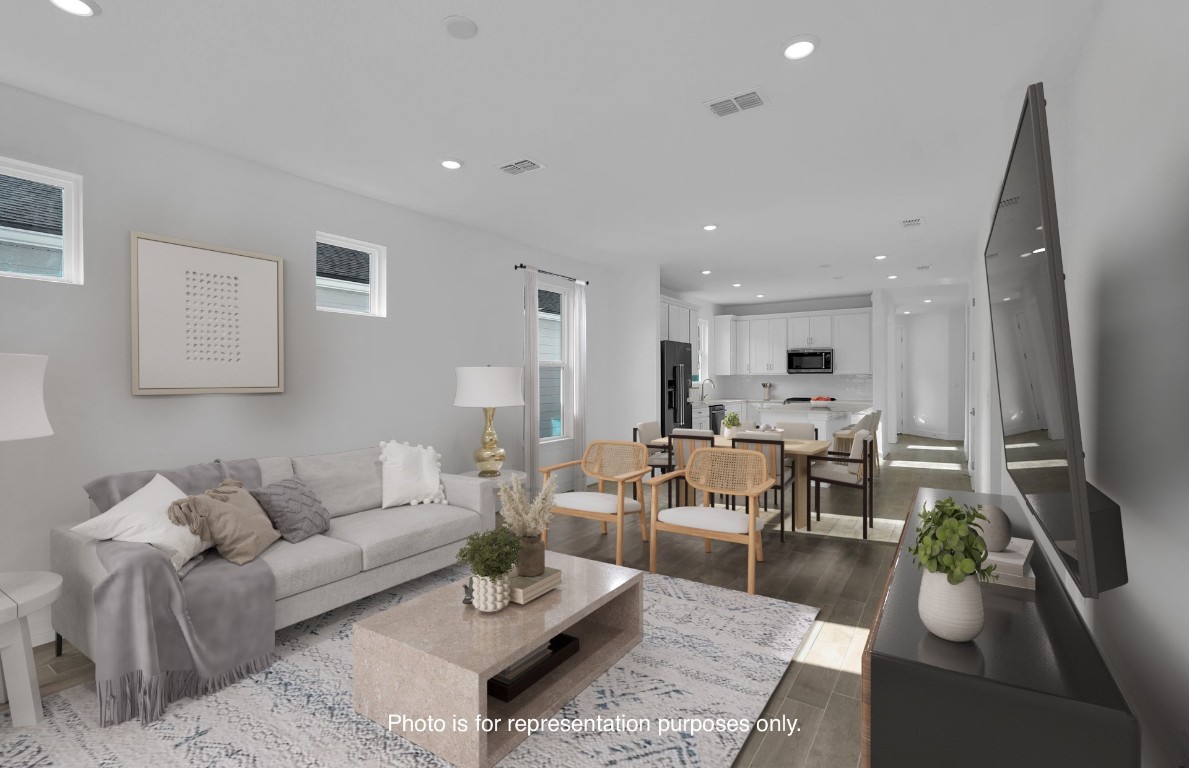 608 Ecliptic Loop Yulee, FL 32097 - Photo 12 of 45 a living room with furniture kitchen view and a potted plant