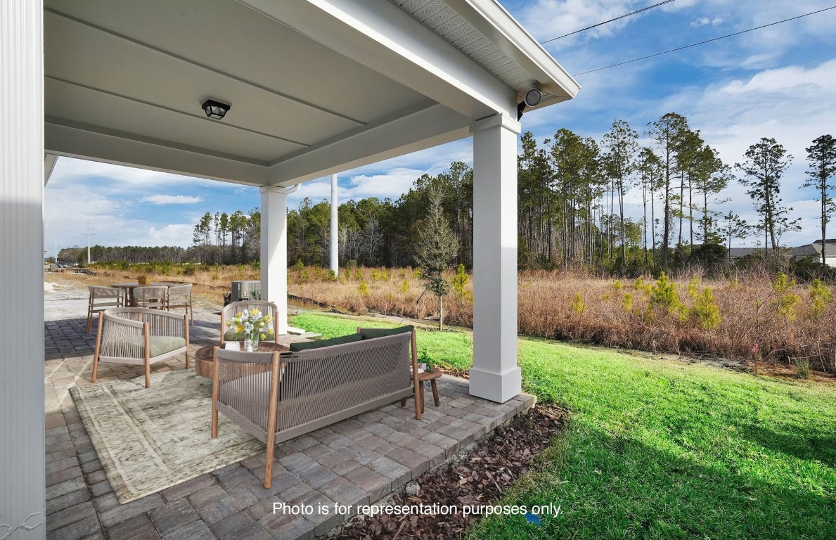 608 Ecliptic Loop Yulee, FL 32097 - Photo 23 of 45 a view of a couches in patio and a yard