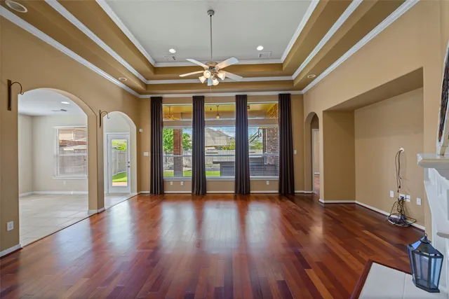a view of an entryway with wooden floors door windows and a chandelier