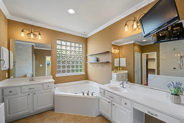 a bathroom with a tub sink and mirror