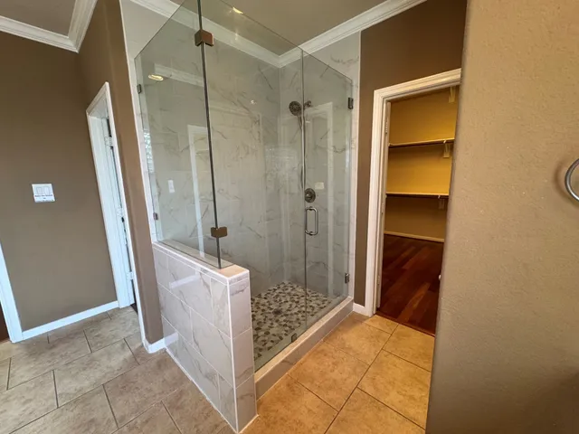 a bathroom with a shower and a sink