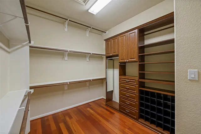 a view of walk in closet with empty racks