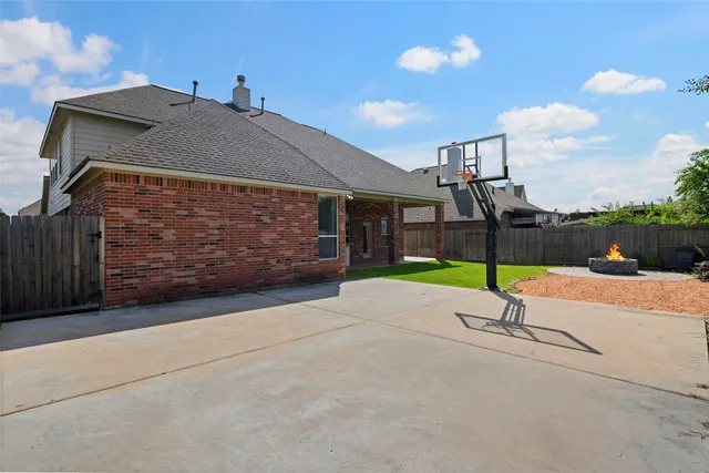 a view of a patio with table and chairs and potted plants