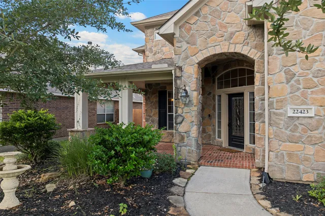 a front view of a house with plants