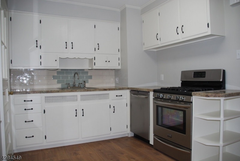 88 Rosedale Avenue Madison, NJ 07940 - Photo 2 of 10 a kitchen with granite countertop white cabinets and stainless steel appliances