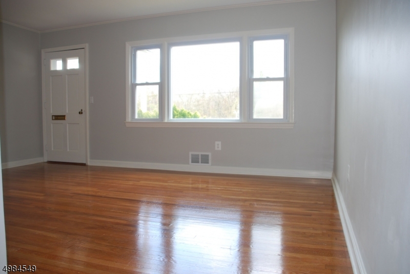 88 Rosedale Avenue Madison, NJ 07940 - Photo 3 of 10 a view of an empty room with wooden floor and a window