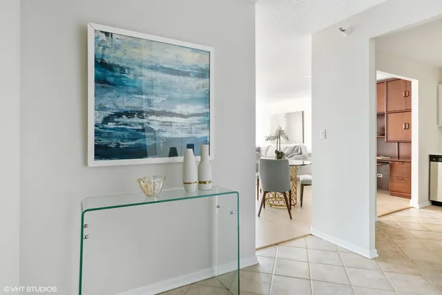 a hallway with a view of kitchen and dining room