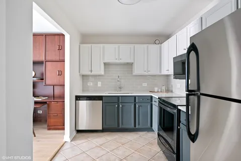 a kitchen with stainless steel appliances granite countertop a refrigerator sink and stove