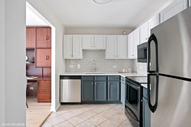 a kitchen with stainless steel appliances granite countertop a refrigerator sink and stove
