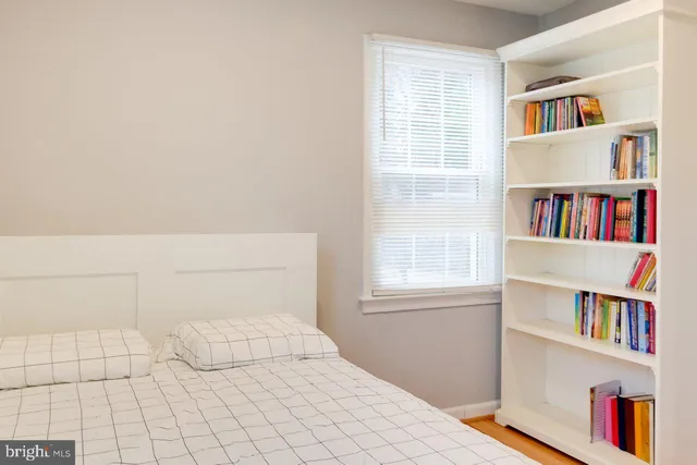 a bedroom with a bed and a book shelf
