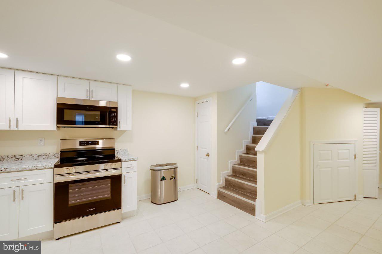 3312 Clay Street Silver Spring, MD 20902 - Photo 18 of 19 a kitchen with white cabinets and stainless steel appliances