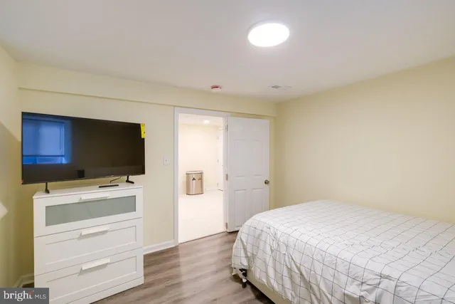 a bedroom with a bed and flat screen tv