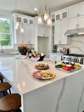 a view of a room that has a large window and front door