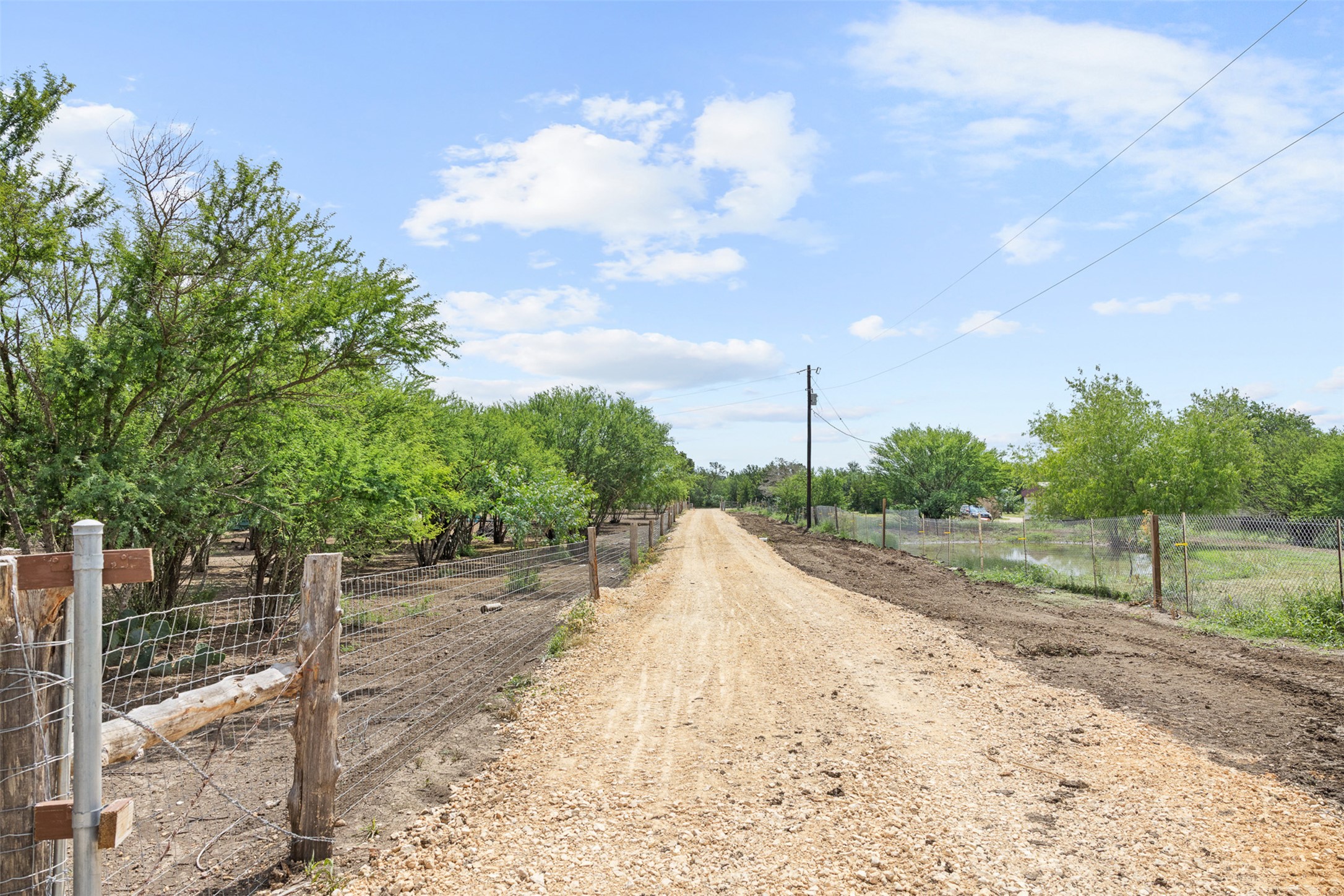 3315 Dry Creek Road Lockhart, TX 78644 - Photo 25 of 26 A long gravel driveway provides direct access to a private, wooded setting.