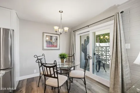a view of a dining room with furniture wooden floor and a chandelier