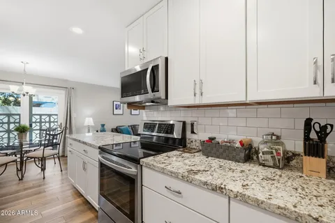 a kitchen with a sink stove and cabinets