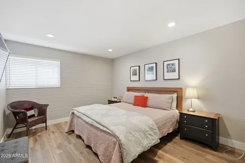 a bedroom with a bed and wooden floor