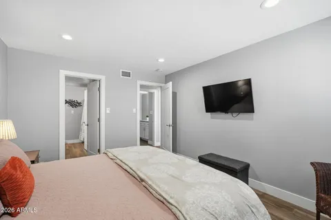 a bedroom with a bed and a flat screen tv