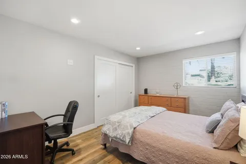 a bedroom with a large bed and a desk