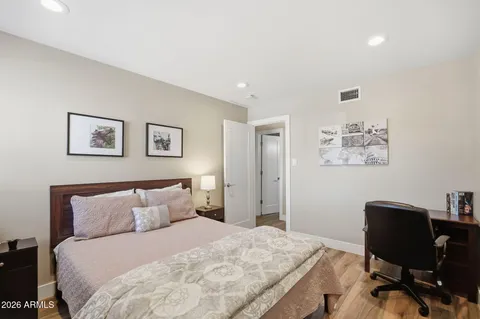 a bedroom with a bed and a desk