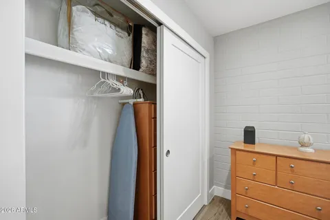 a view of walk in closet with clothes