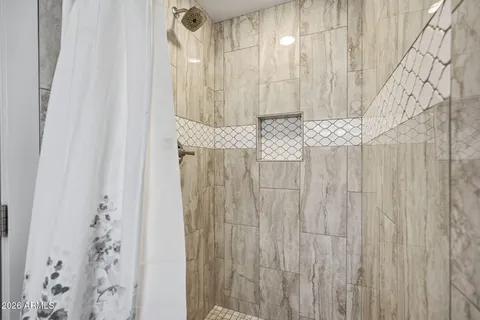 a bathroom with a shower curtain and a curtain