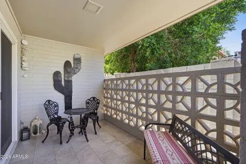 a view of a chairs and table in the balcony